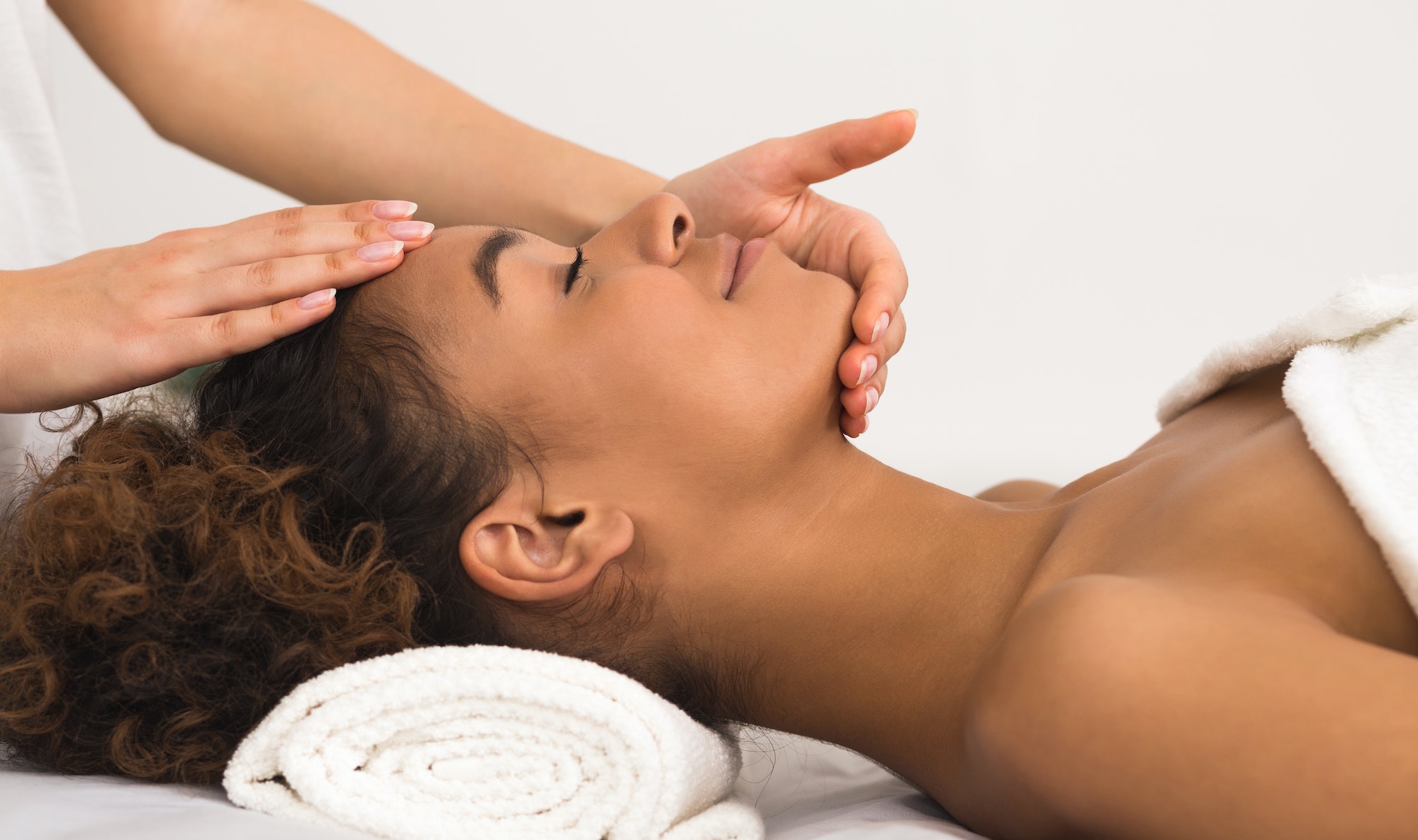 Face treatment concept. Woman enjoying anti aging facial massage